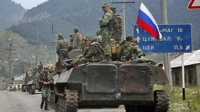 A column of Russian armored vehicles, heading towards the breakaway Georgian province of South Ossetia, are seen in North Ossetia, Russia, Friday, Aug. 8, 2008. A surprise military offensive by Georgia, a staunch U.S. ally, to retake the breakaway province of South Ossetia reportedly killed hundreds of people Friday, triggering a ferocious counterattack from Russia that threatened to plunge the region into full-scale war. (AP Photo/Musa Sadulayev)