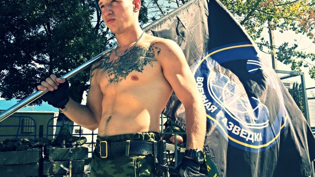 Фотографія Раменського з прапором воєнної розвідки і неонацистським татуюванням